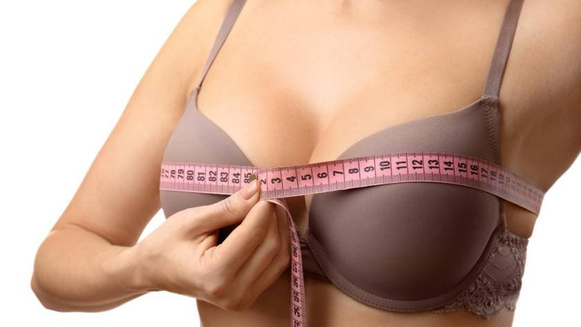 Woman measuring bust size before breast augmentation surgery in Tijuana
